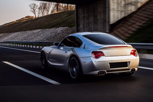 back-side-view-metallic-silver-coupe-road_114579-4049