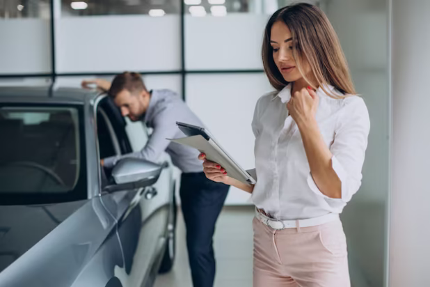 business-man-choosing-car-with-sales-woman-car-salon_1303-28512