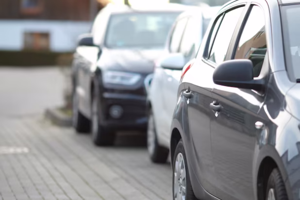 closeup-shot-black-car-parking-lot-with-blurred-background_181624-20473