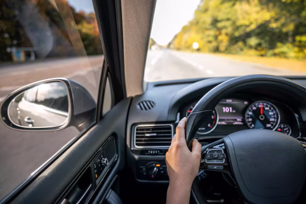 woman-drivers-hands-steering-wheel-inside-car_169016-46605