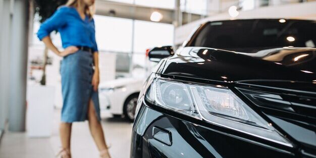 woman-looking-car-car-showroom_1303-15192