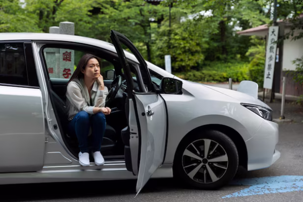 woman-sitting-her-electric-car_23-2149457992