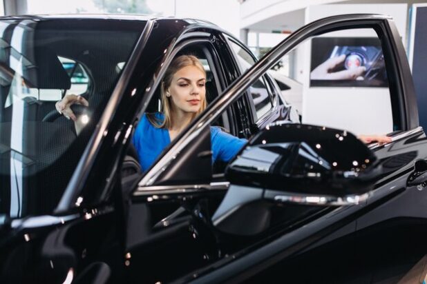 woman-sitting-inside-car-car-showroom_1303-15214