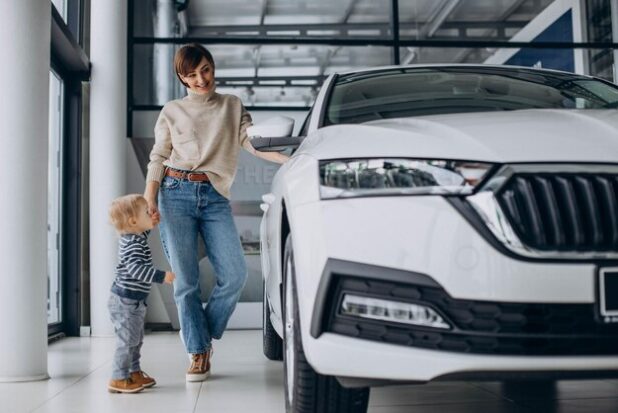 woman-with-baby-son-choosing-car-car-salon_1303-30380