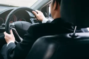 Driver profesional Iwan Rental Mobil sedang mengantar penumpang dengan aman dan ramah di Pekanbaru.
